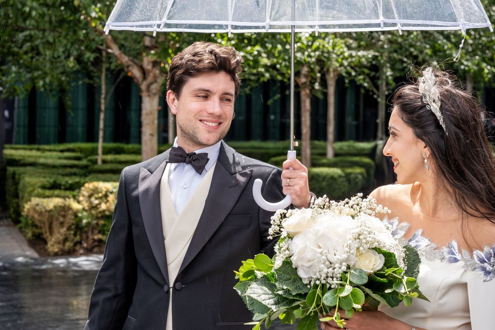 Bride and groom share a romantic moment in a lush garden setting during their wedding celebration.