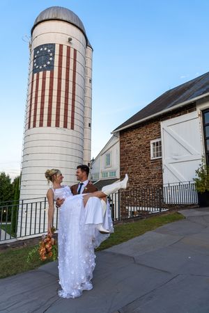 A sequence of artistic wedding photos captured against a rustic silo painted with an American flag design.
