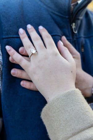 Close-up sequence of hands holding and interacting with a mobile phone device against a dark blue background.