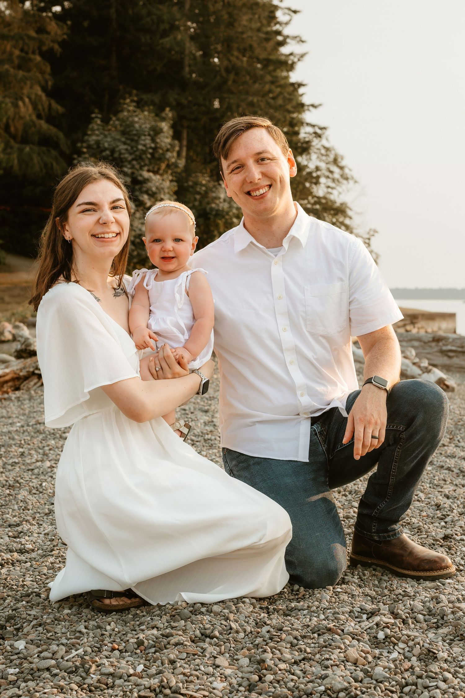 Portrait of a young family with a toddler on a beach.