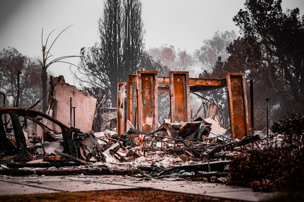 Destroyed building with standing brick columns and rubble from fire damage.