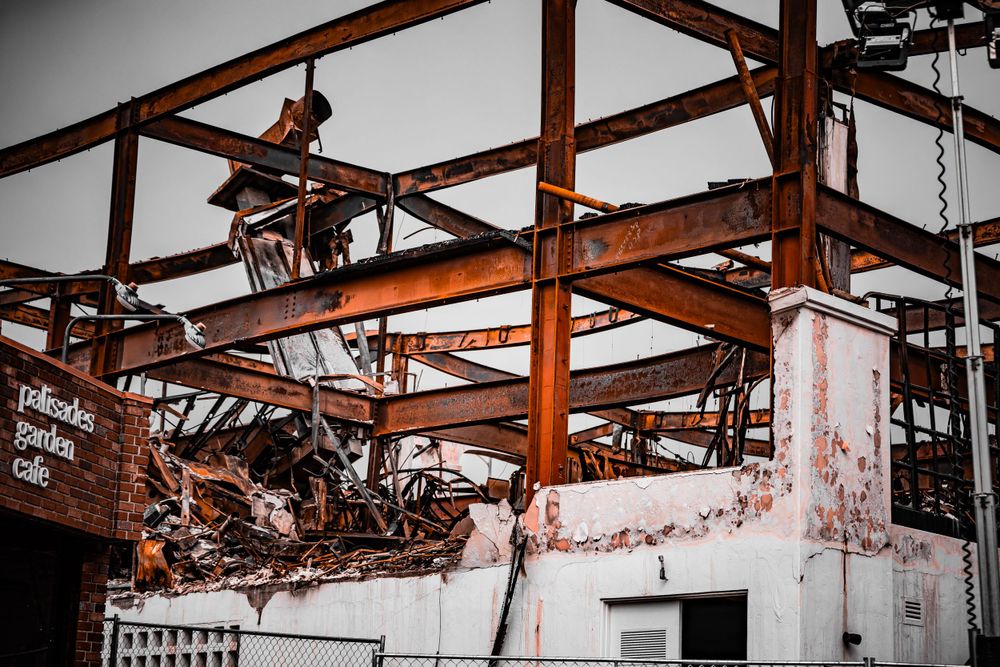 Damaged building framework revealing structural remains after destructive event.