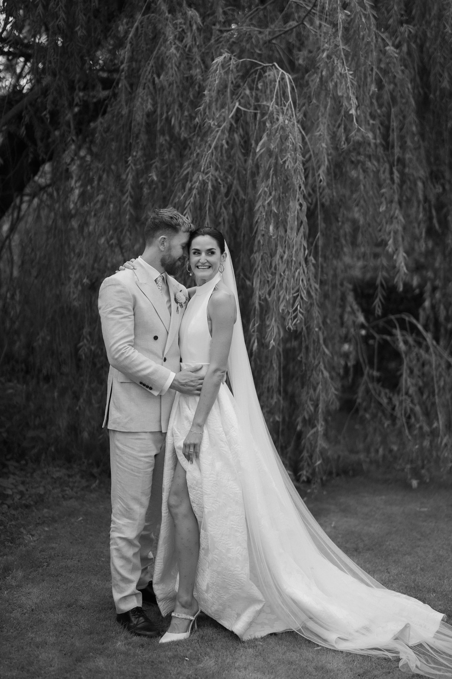 bride and groom under willow tree in islip in oxfordshire