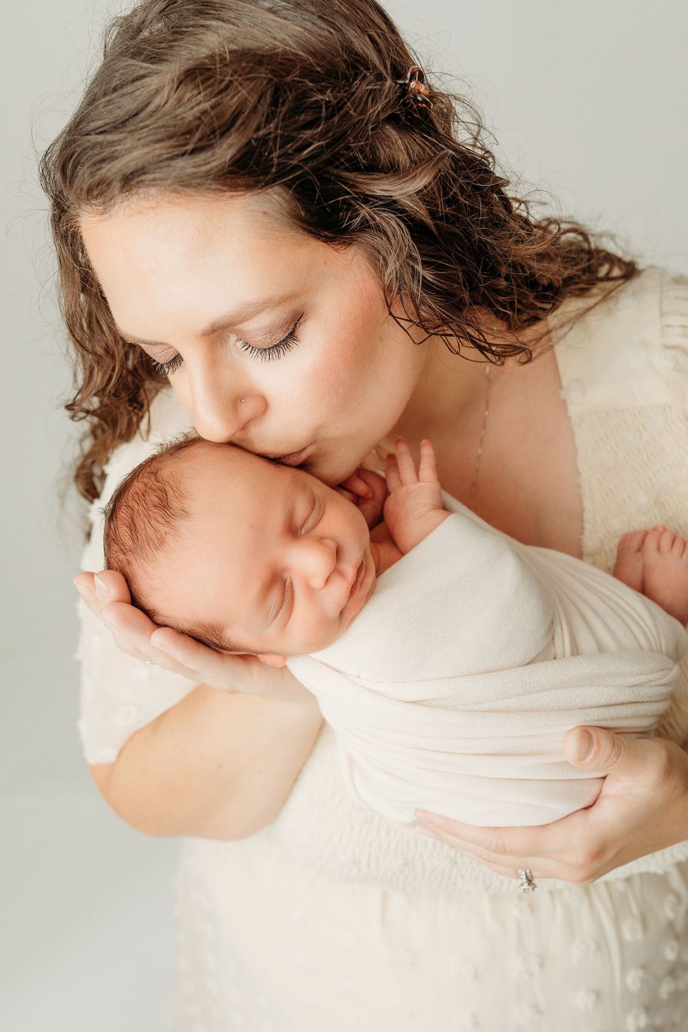 A tender and intimate moment captured in soft natural light showing gentle affection and connection.