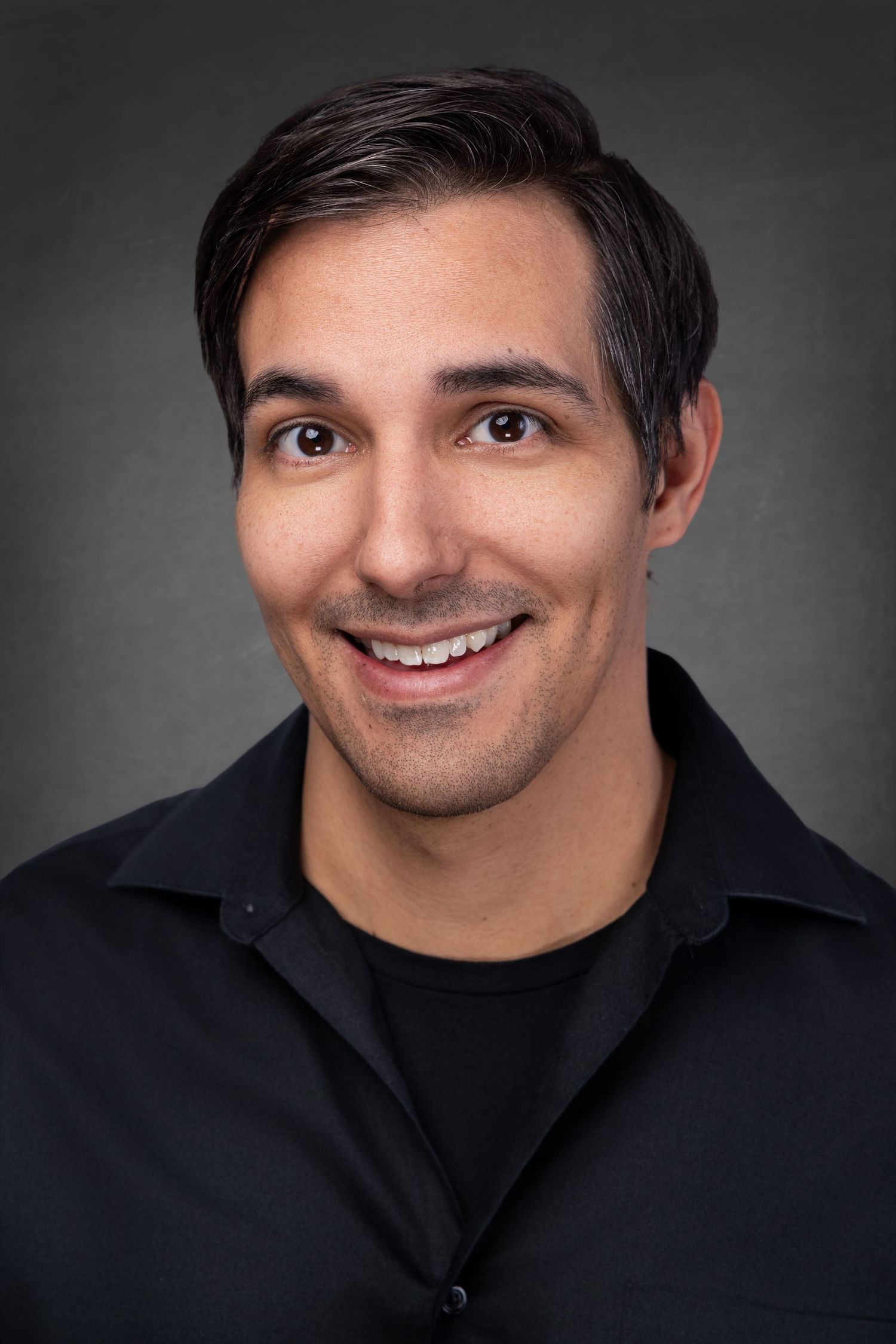 Professional headshot series showing different expressions and angles against dark background wearing black shirt.