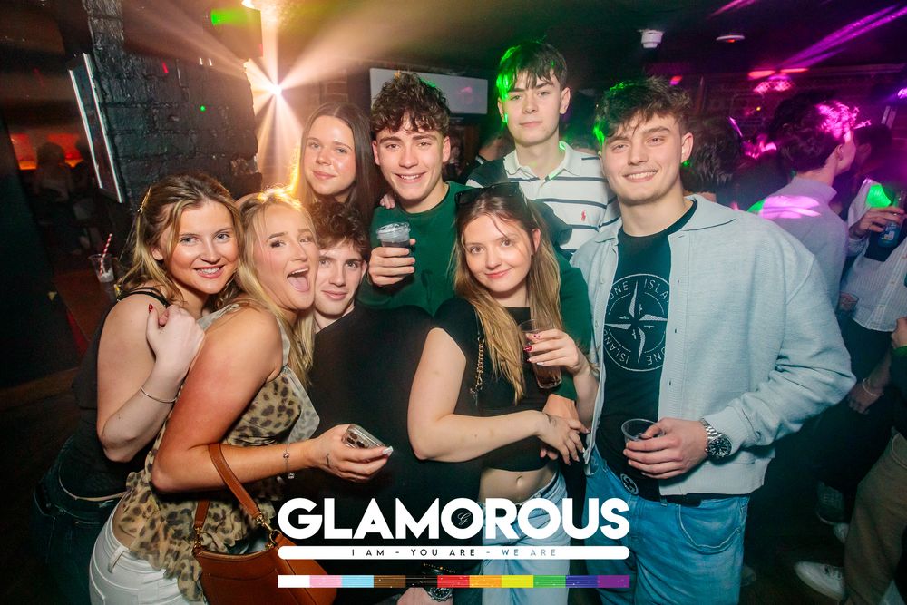 Nightclub scene with colorful lighting and party atmosphere showing people enjoying music.