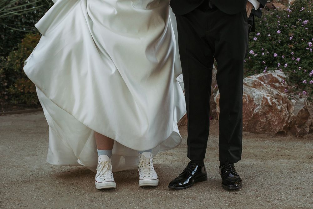 Wedding couple's shown in formal shoes and white dress during a photo shoot at River Garden Weddings and Events.