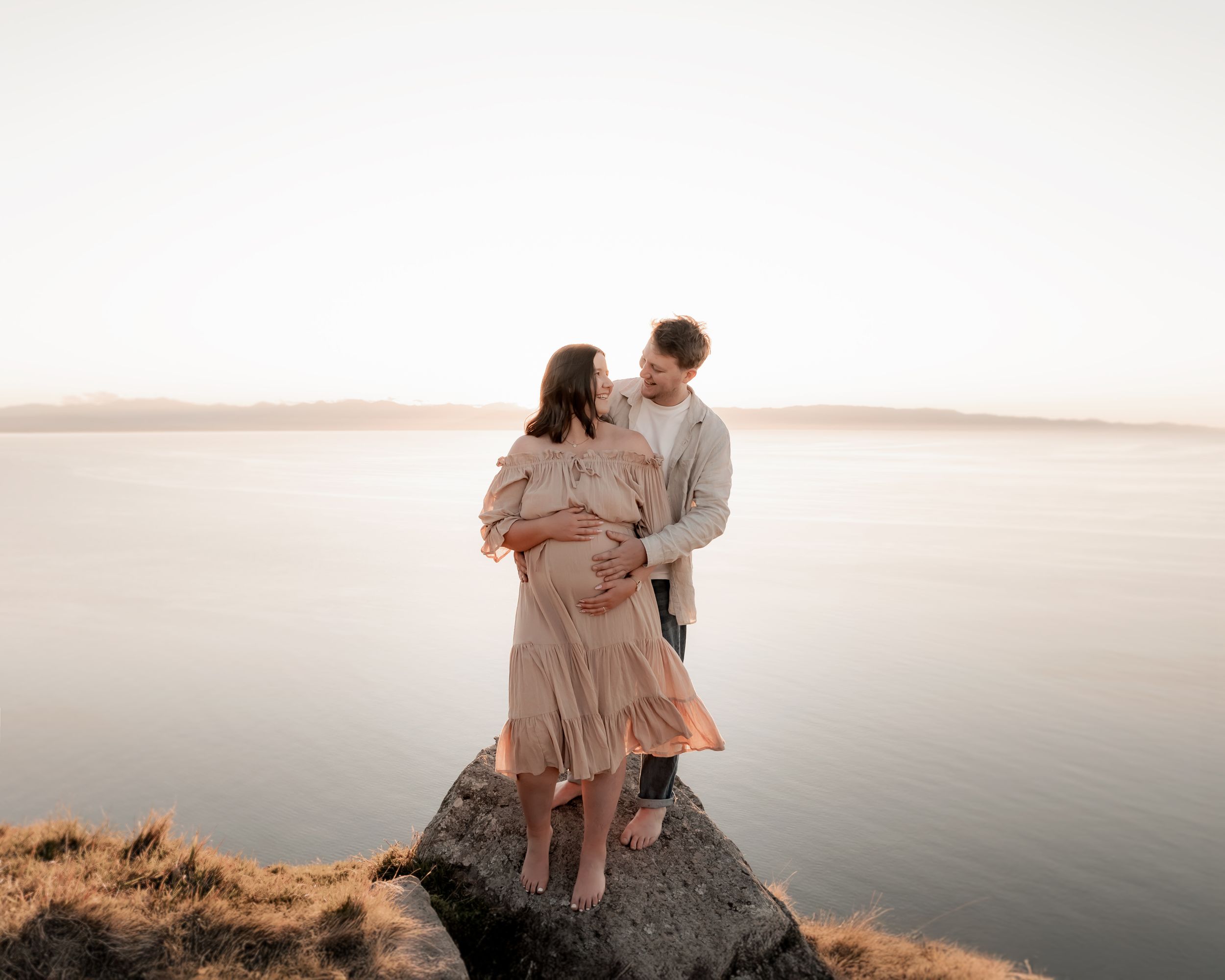 Expectant parents embracing during maternity photography session