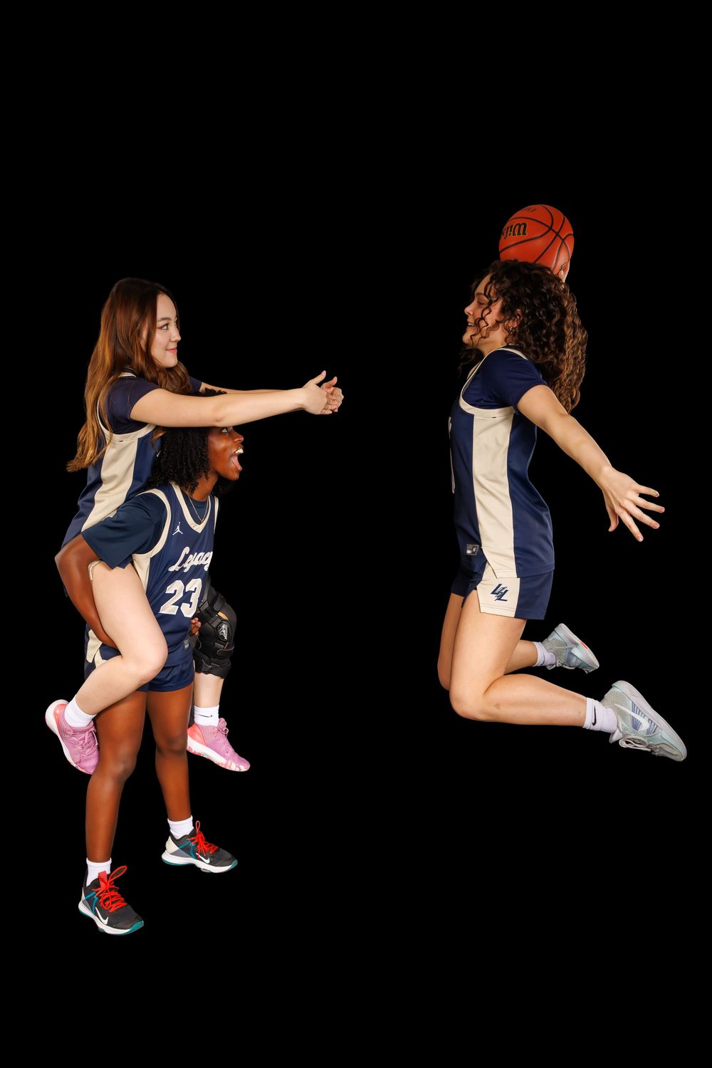 Basketball players in navy jerseys demonstrating dynamic action poses with a basketball.