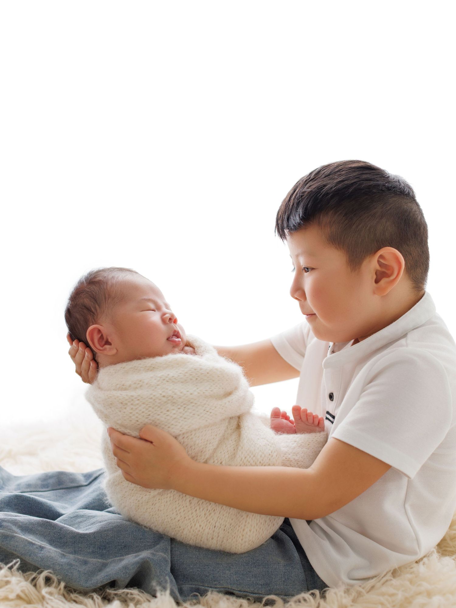 A series of connected photos showing a sleeping baby in white clothing lying on soft textured bedding.