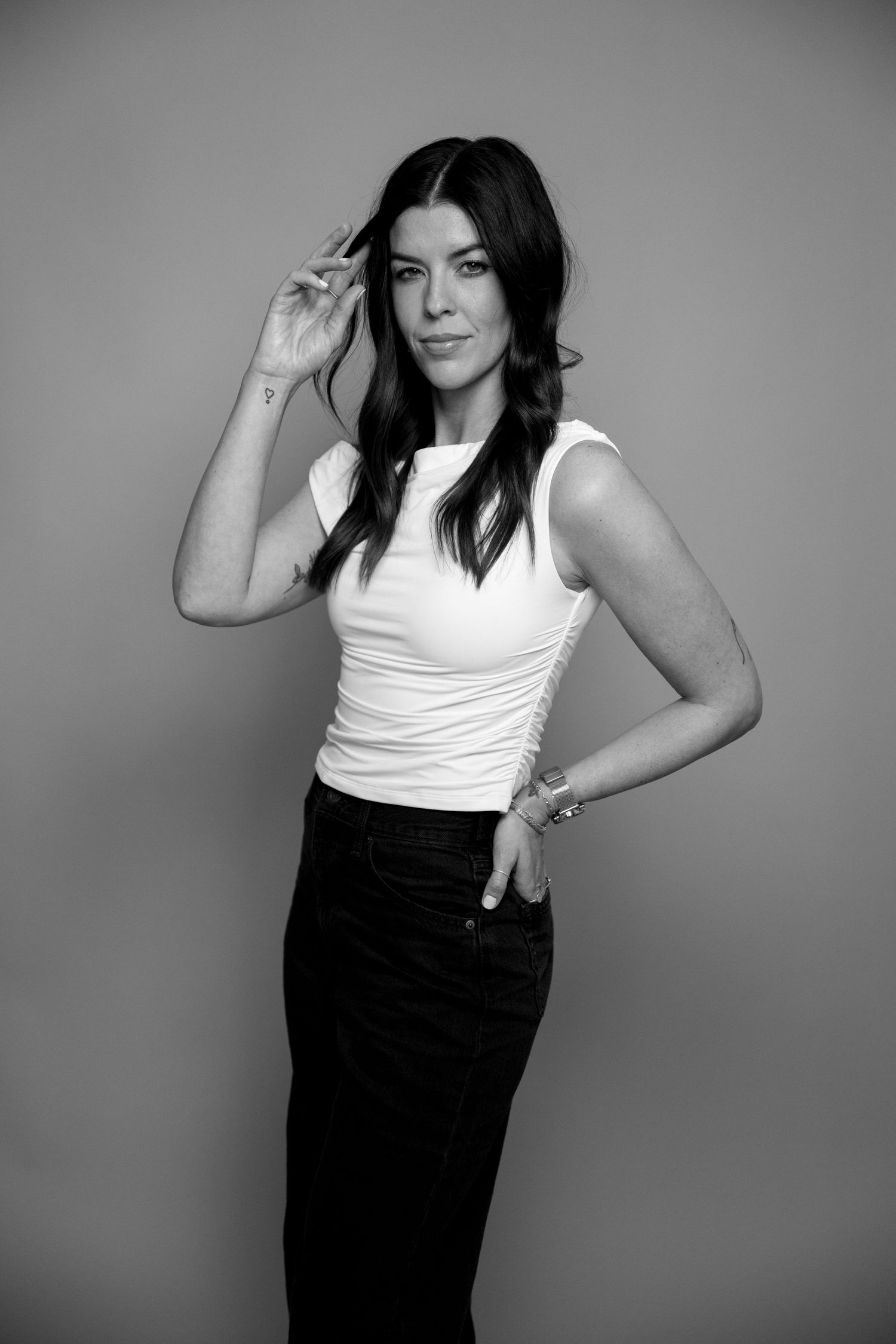 Black and white fashion portraits showing dynamic poses in contrasting monochrome outfit.