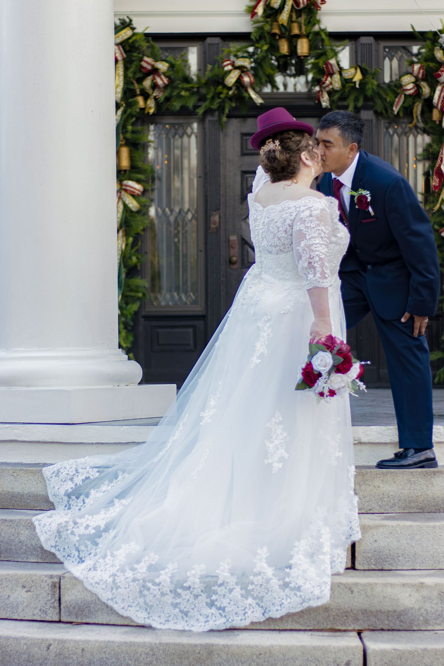 A detailed white lace wedding dress with a long flowing train is showcased from different angles on stone steps.
Wedding photography