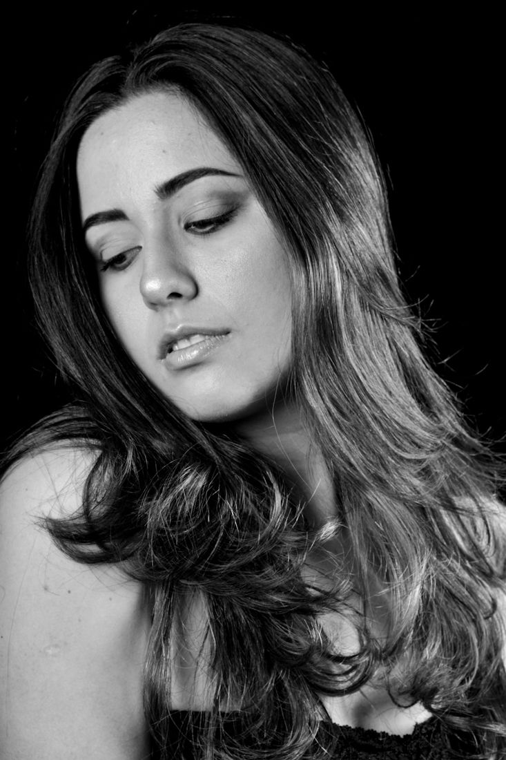 Black and white artistic portrait series showing dramatic lighting and hair styling.