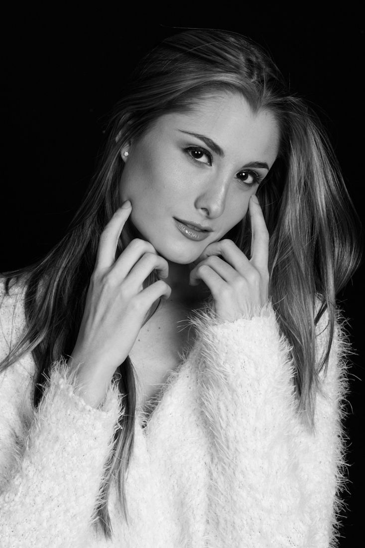 Portrait series in black and white wearing fluffy white sweater with expressive poses.