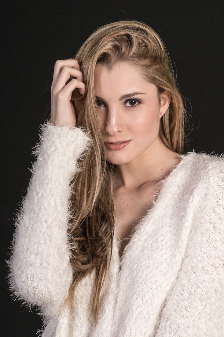 Studio fashion series showing poses in a plush white winter sweater.