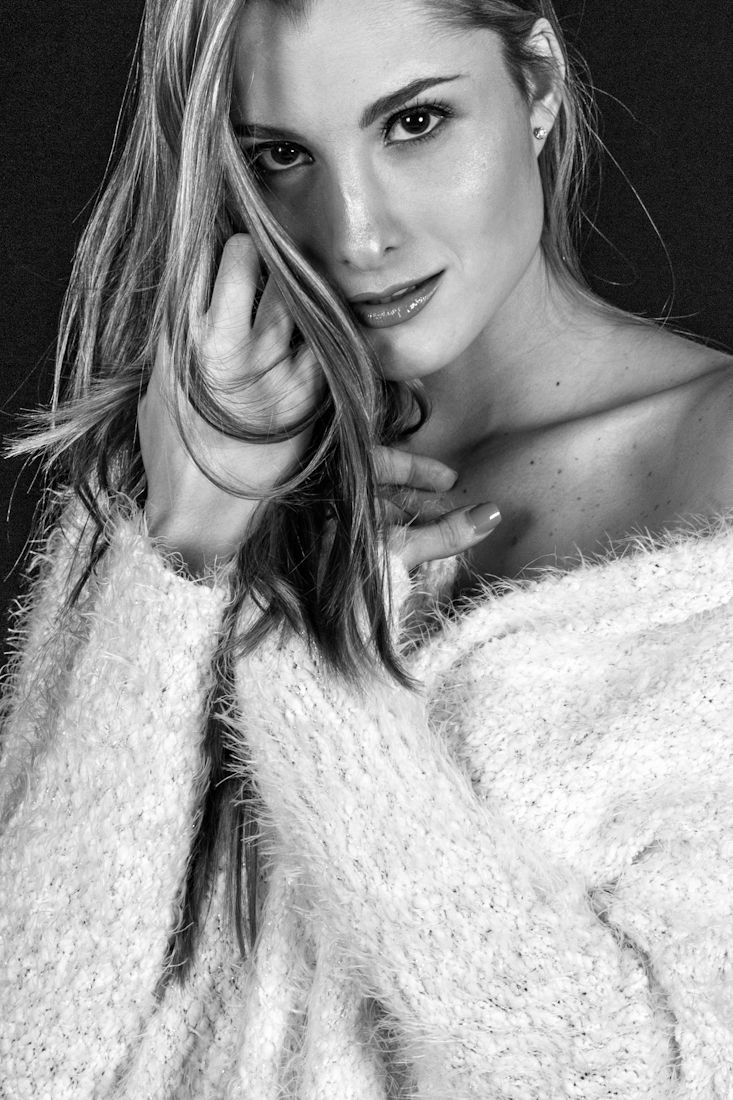 Artistic black and white portrait series featuring dramatic poses in white textured garment.