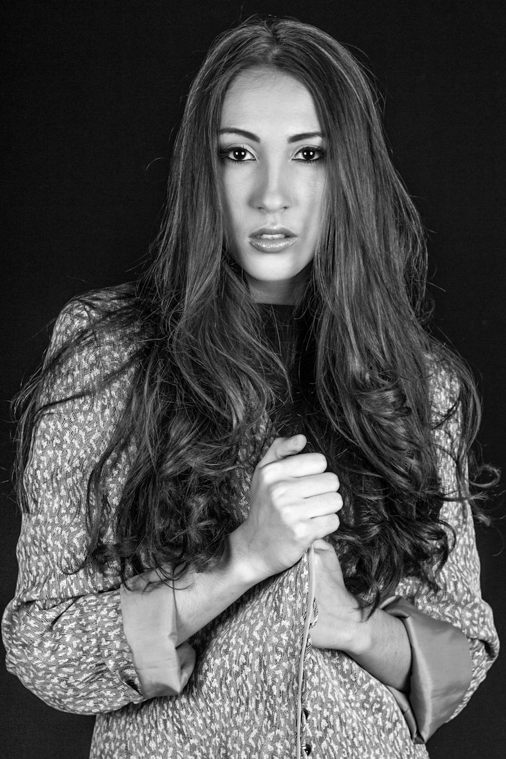 Black and white portrait series showing woman in patterned top with long dark hair against dark background.
