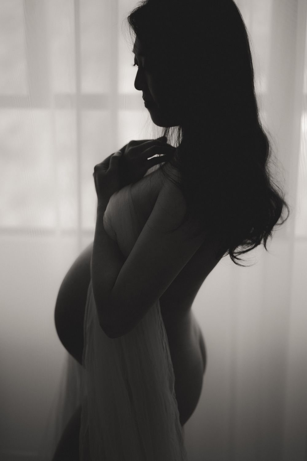 A series of silhouette portraits showing an elegant figure in black and white with soft lighting and shadows.