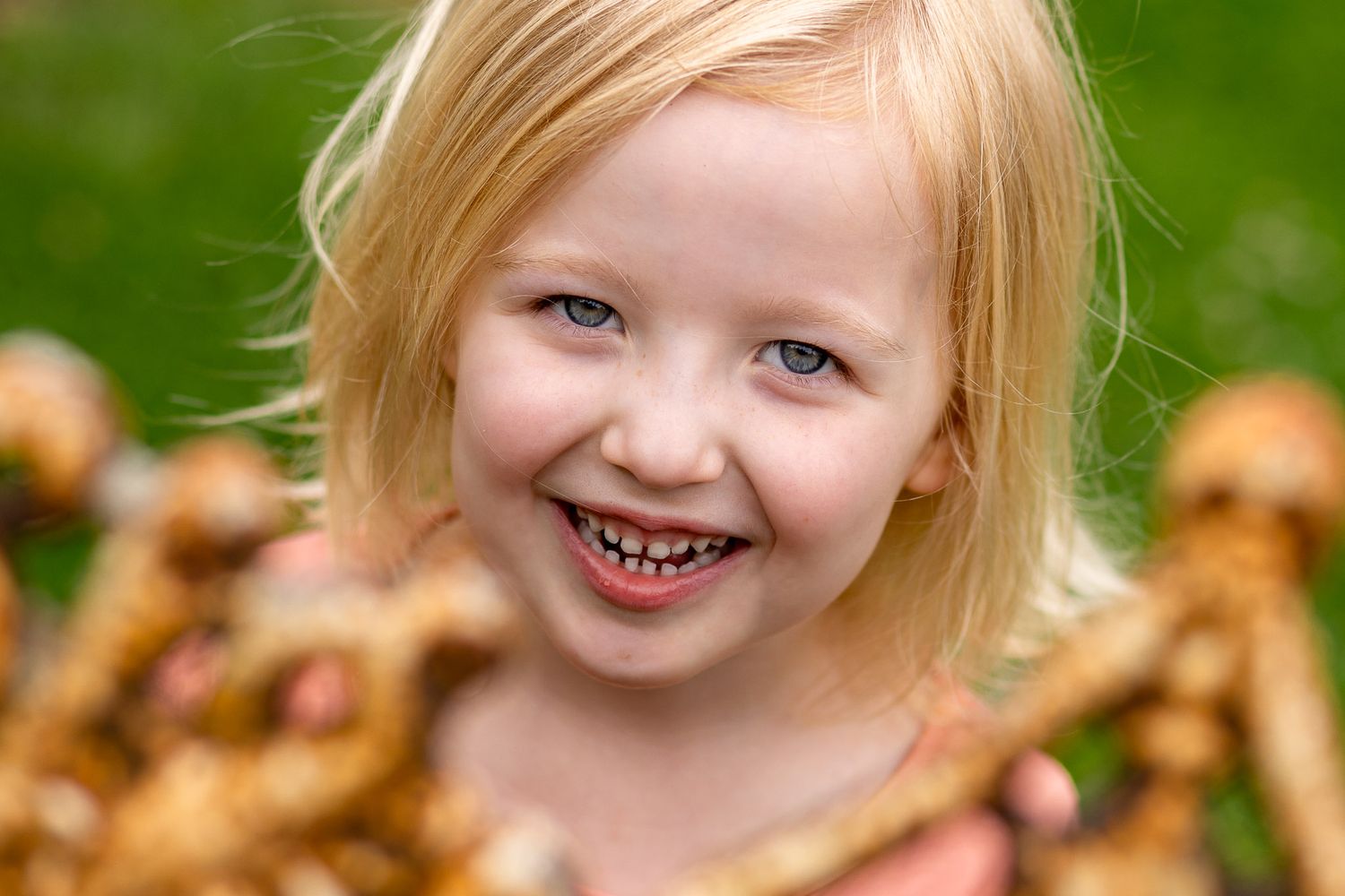 A collage of autumn portraits shows someone with blonde hair smiling and playing in fallen orange leaves.