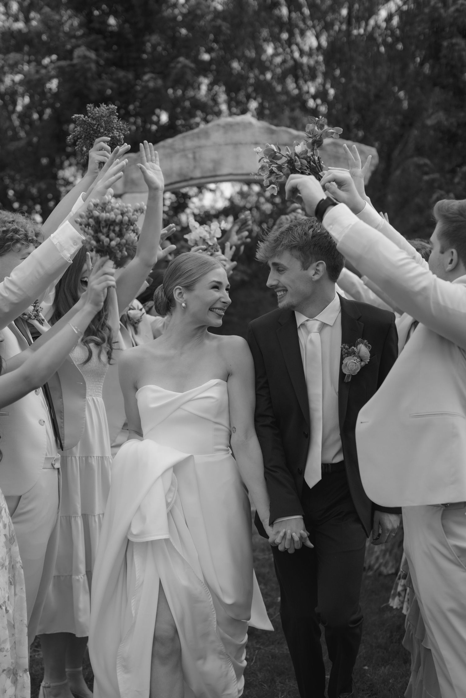 A joyful family moment captured in black and white as they lift their children.