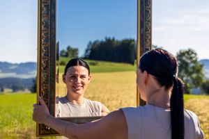 A series of ornate golden frames displayed against a bright yellow field background.