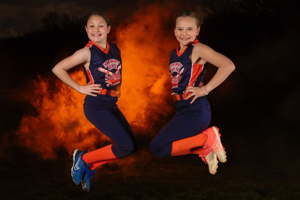 Recreational softball players and coach with dramatic lighting in Hershey PA, photographed by SportsFox Photography.