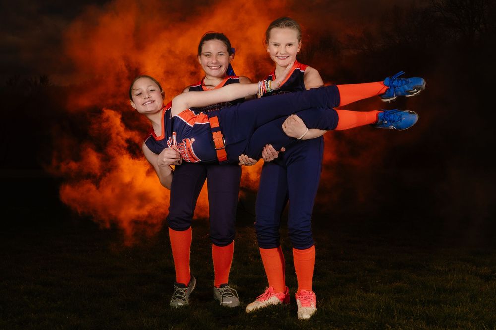 Recreational softball players and coach with dramatic lighting in Hershey PA, photographed by SportsFox Photography.