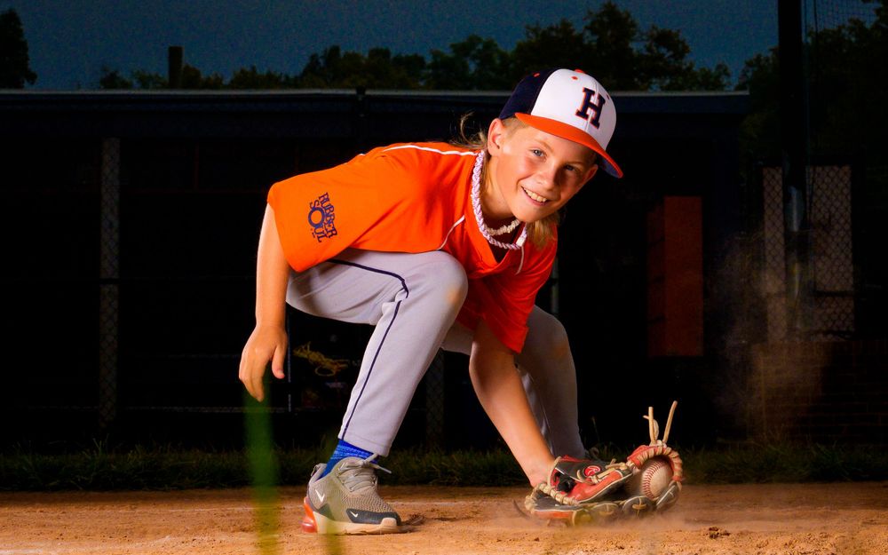 Little League All-Star baseball player at home plate with dramatic lighting in Hershey PA, photographed by SportsFox Photography.