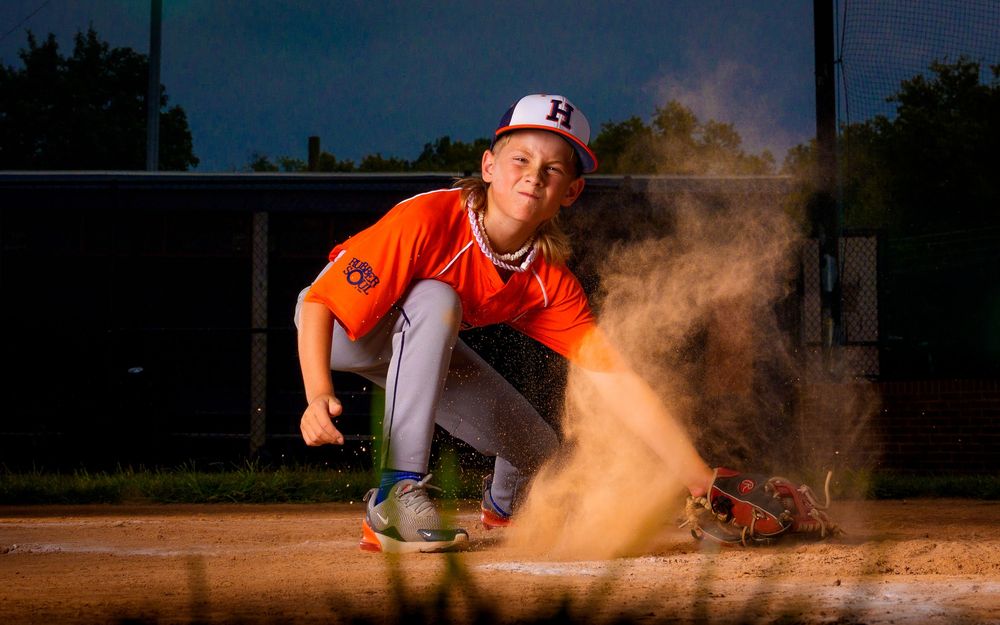 Little League All-Star baseball player at home plate with dramatic lighting in Hershey PA, photographed by SportsFox Photography.