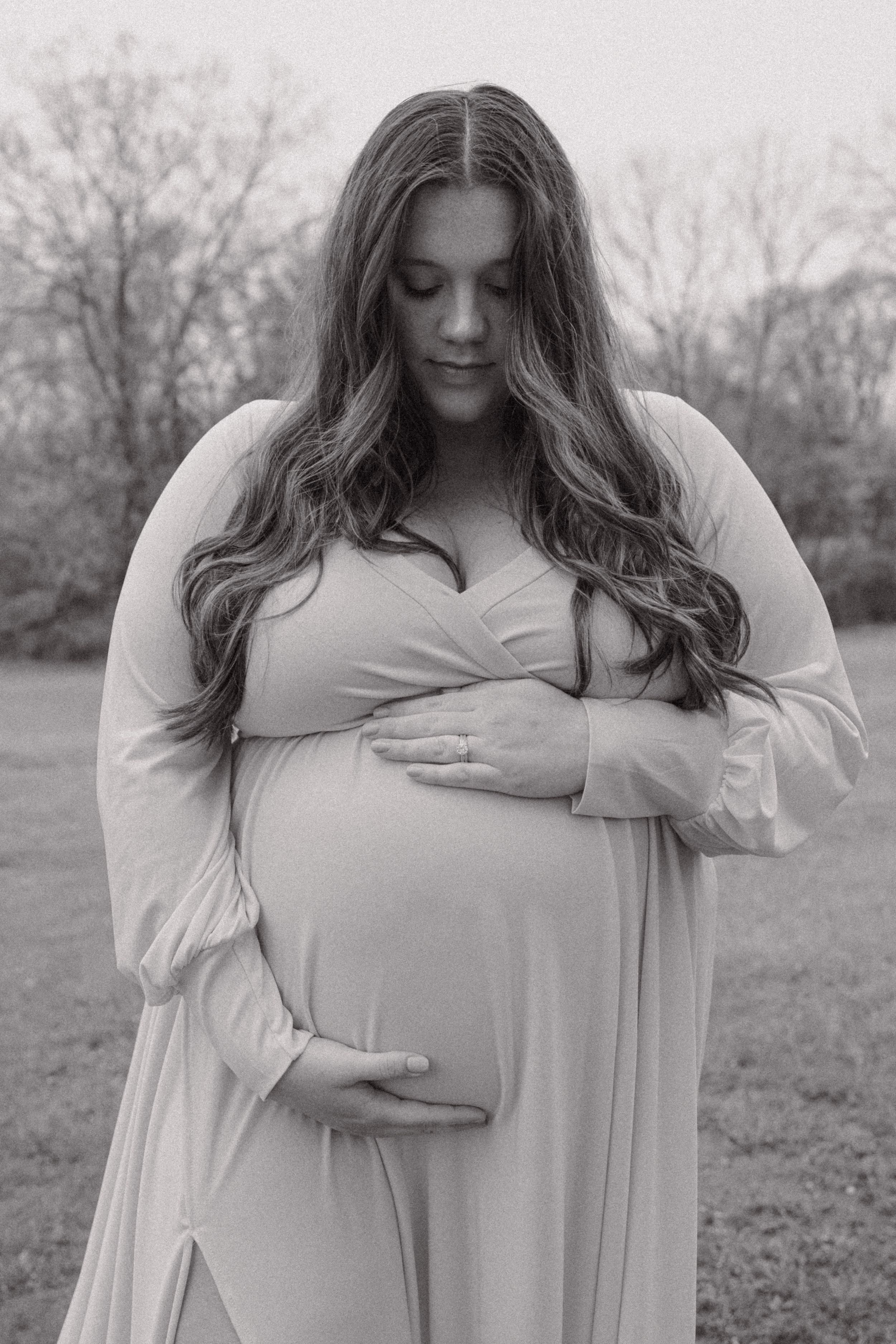 Black and white maternity photos showing gentle poses and tender moments.