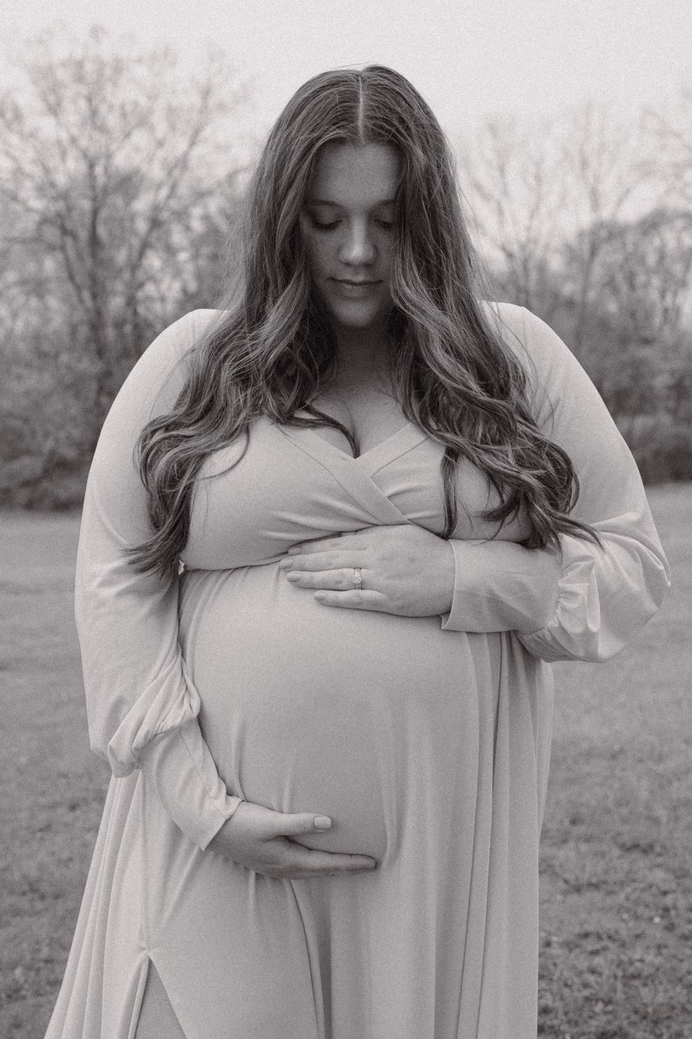 Black and white maternity photos showing gentle poses and tender moments.