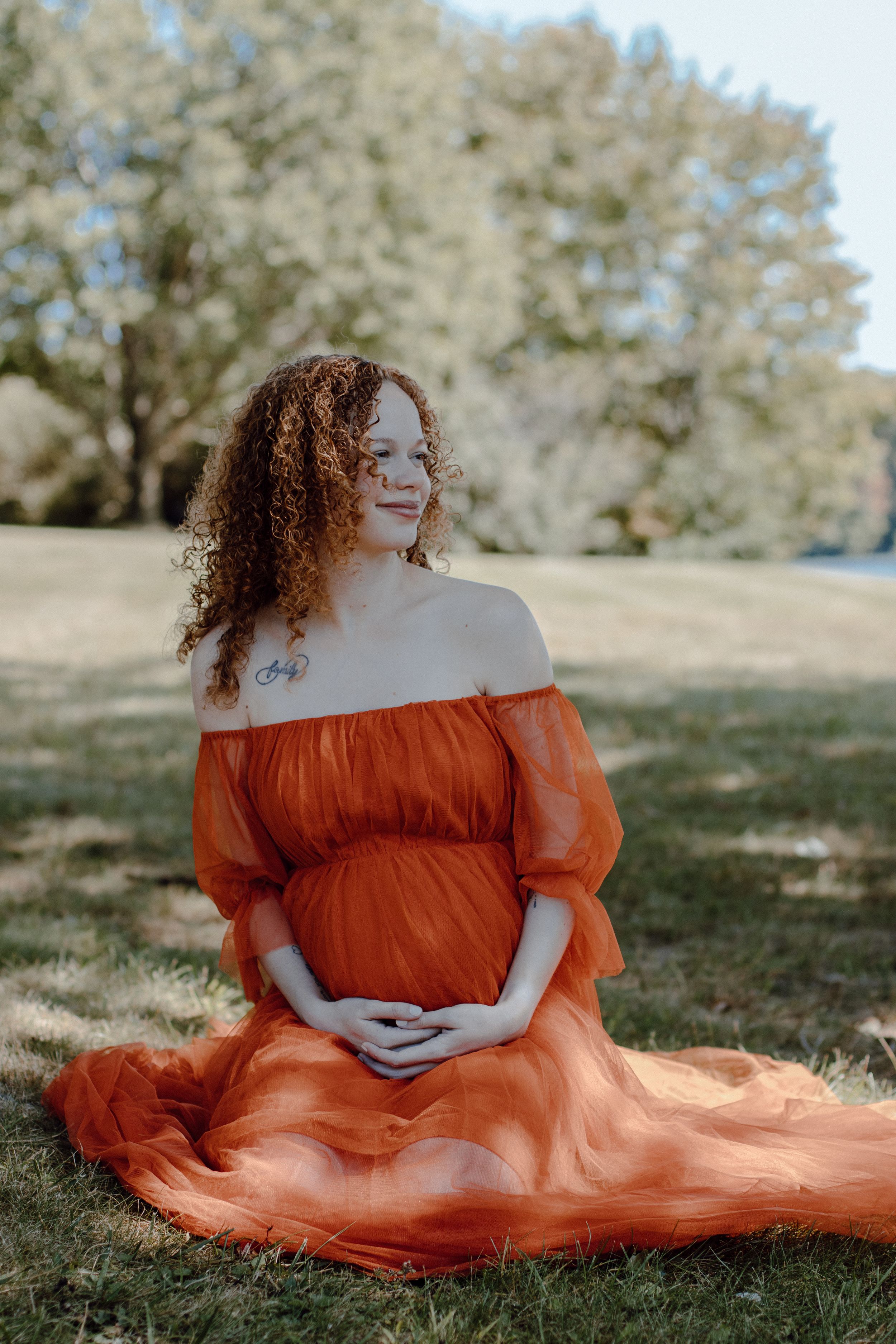 Romantic outdoor photography with flowing orange fabric and natural lighting.
