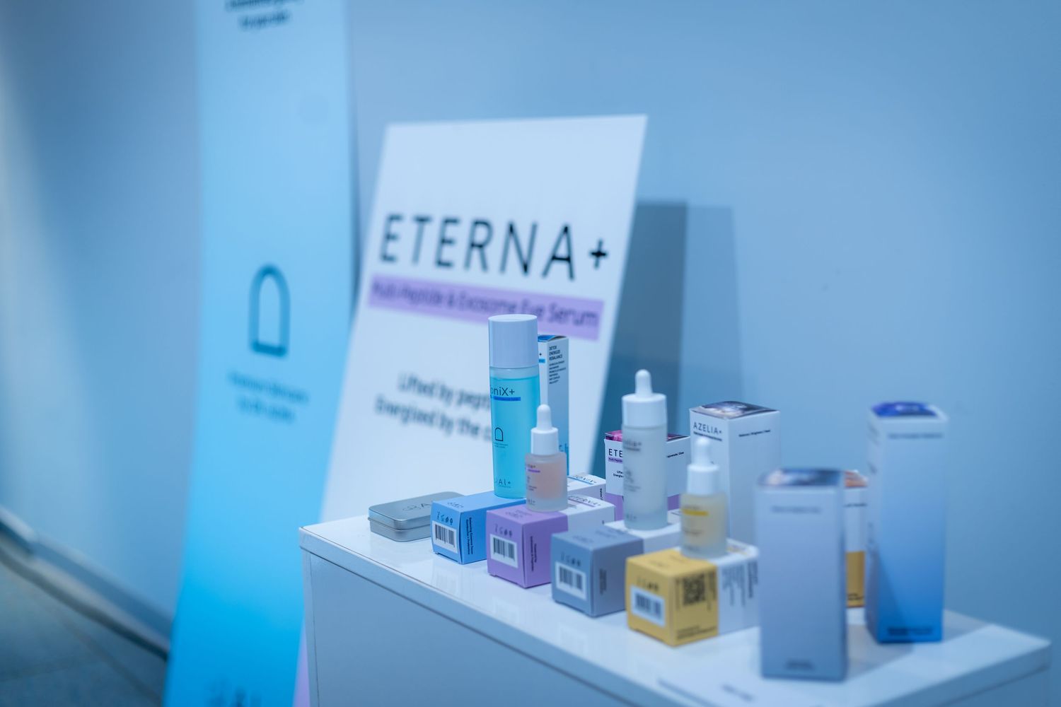 ETERNA+ skincare product display with blue and white packaging on a white shelf.