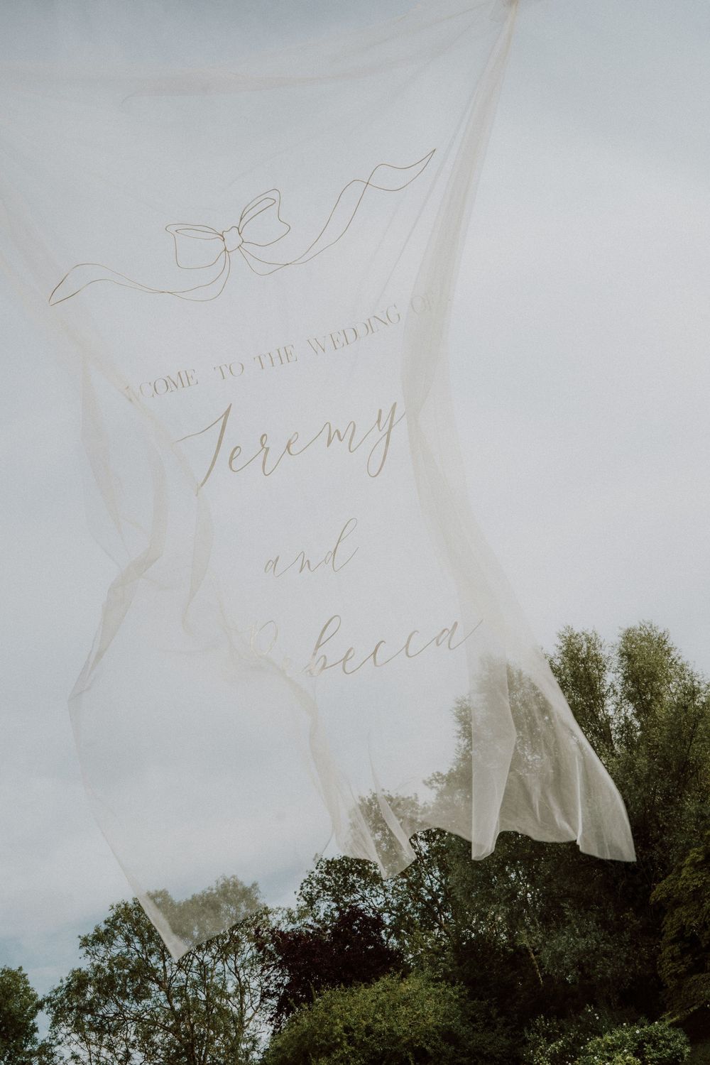 Handwritten text overlays a scenic view of green trees against a cloudy sky background at Sudeley Castle, Cotswolds