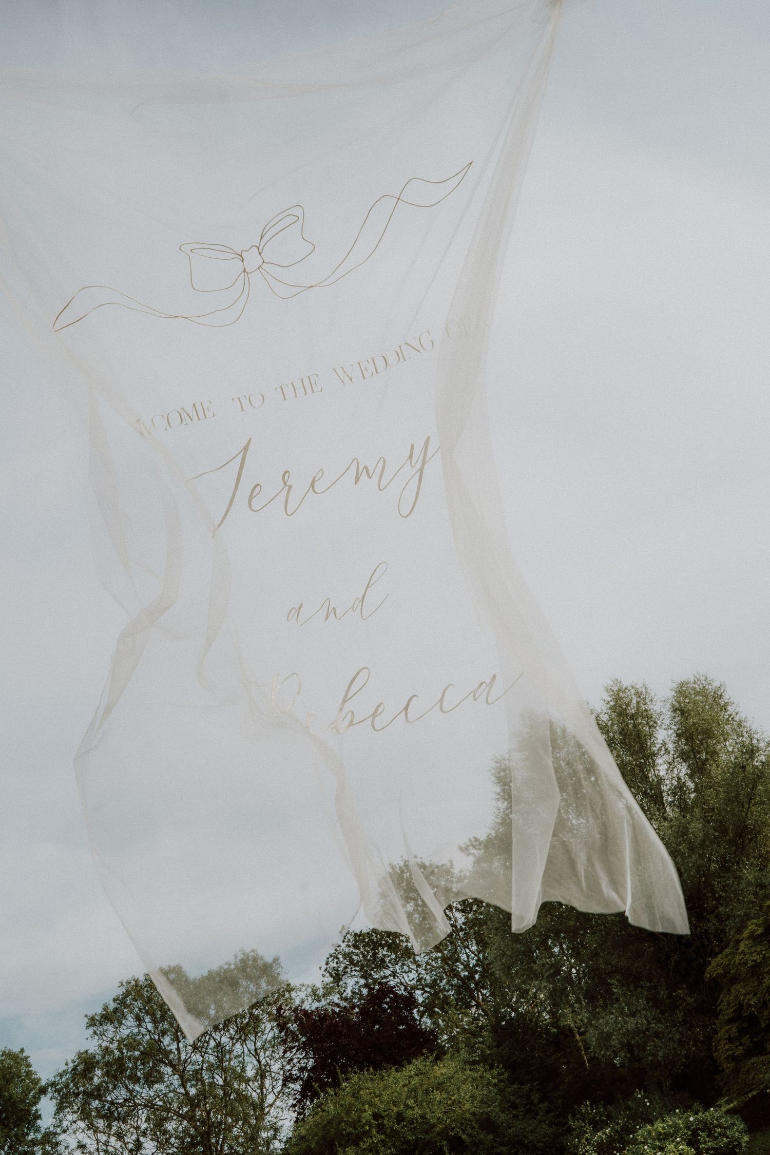 Handwritten text overlays a scenic view of green trees against a cloudy sky background at Sudeley Castle, Cotswolds