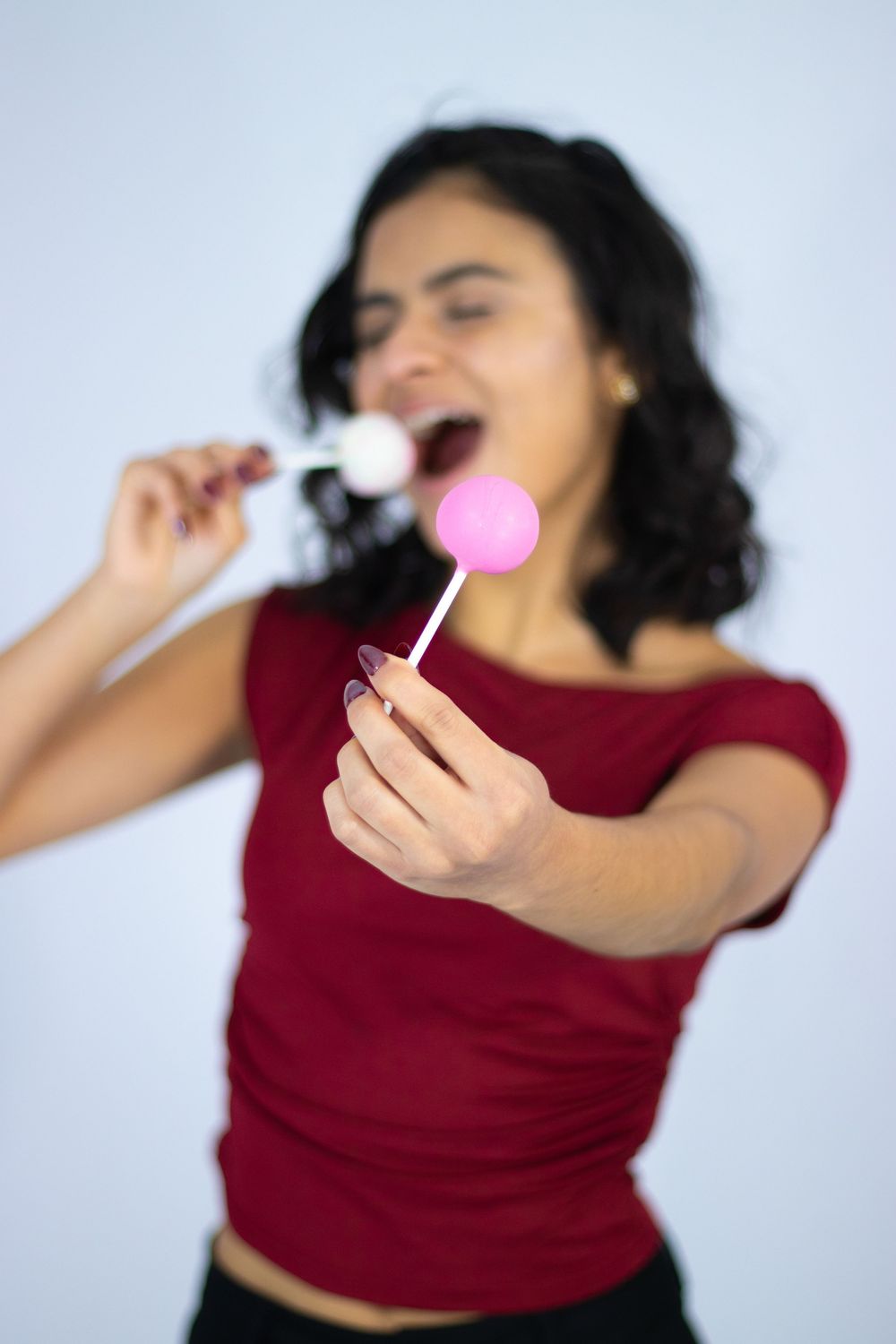 A person in a burgundy top dances expressively in a four-panel sequence against a light background.