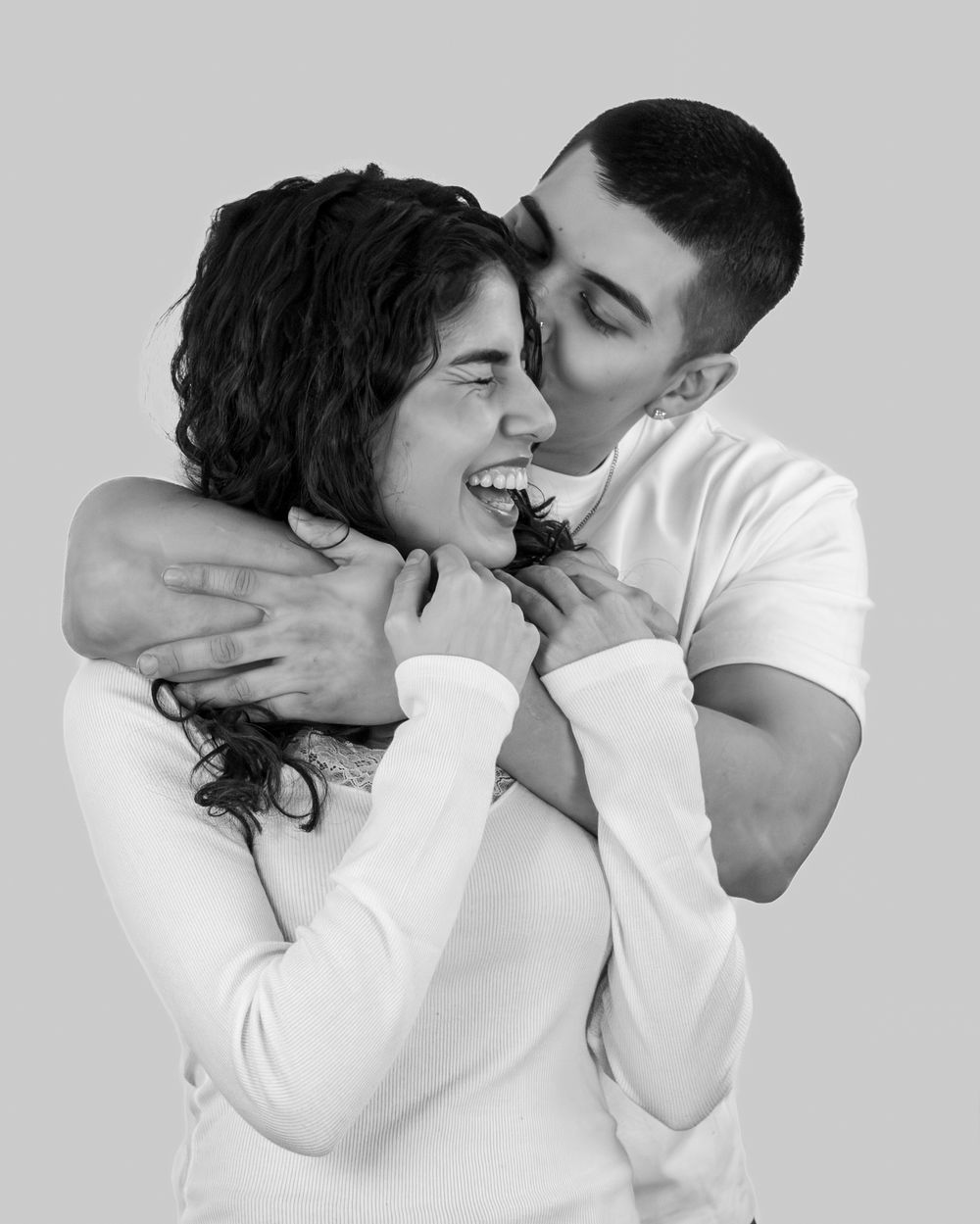 A series of four black and white romantic photos showing an intimate couple embracing and sharing tender moments.