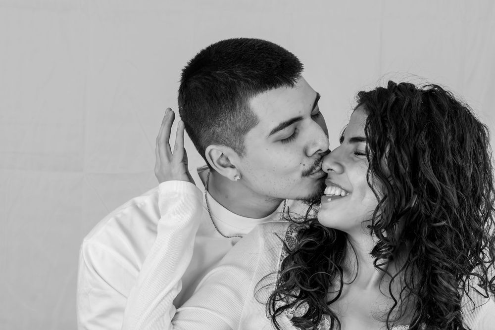 A romantic black and white photo series showing an intimate couple embracing and kissing in various poses.