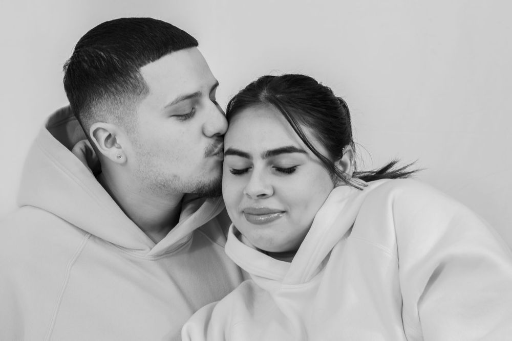 A series of black and white intimate photos showing tender romantic moments between a couple.