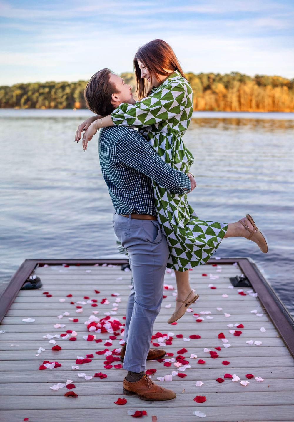 Newly engaged couple hugging on dock at Ritz-Carlton Lake Oconee