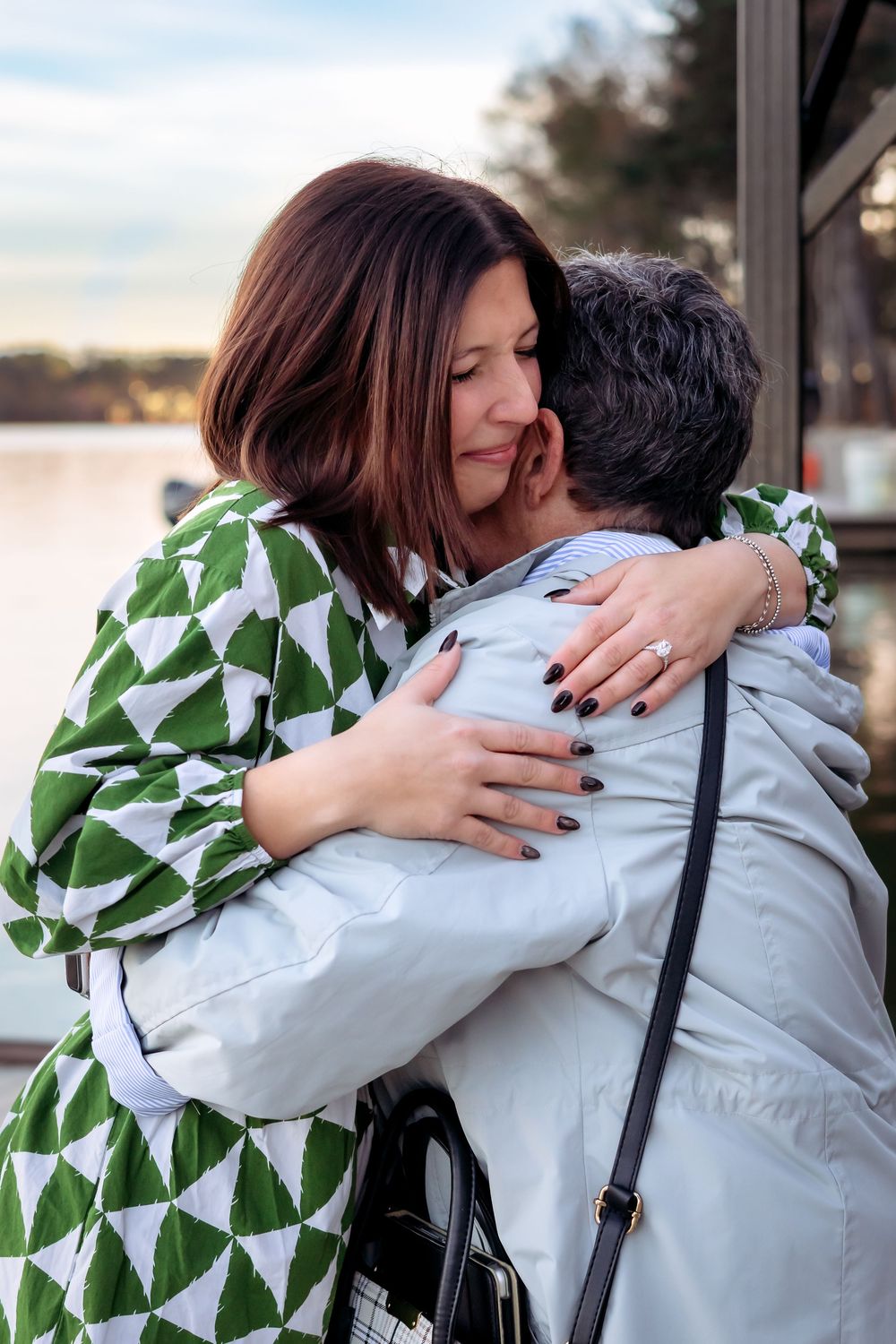 Hugging grandma after romantic lakeside engagement proposal at Lake Oconee resort