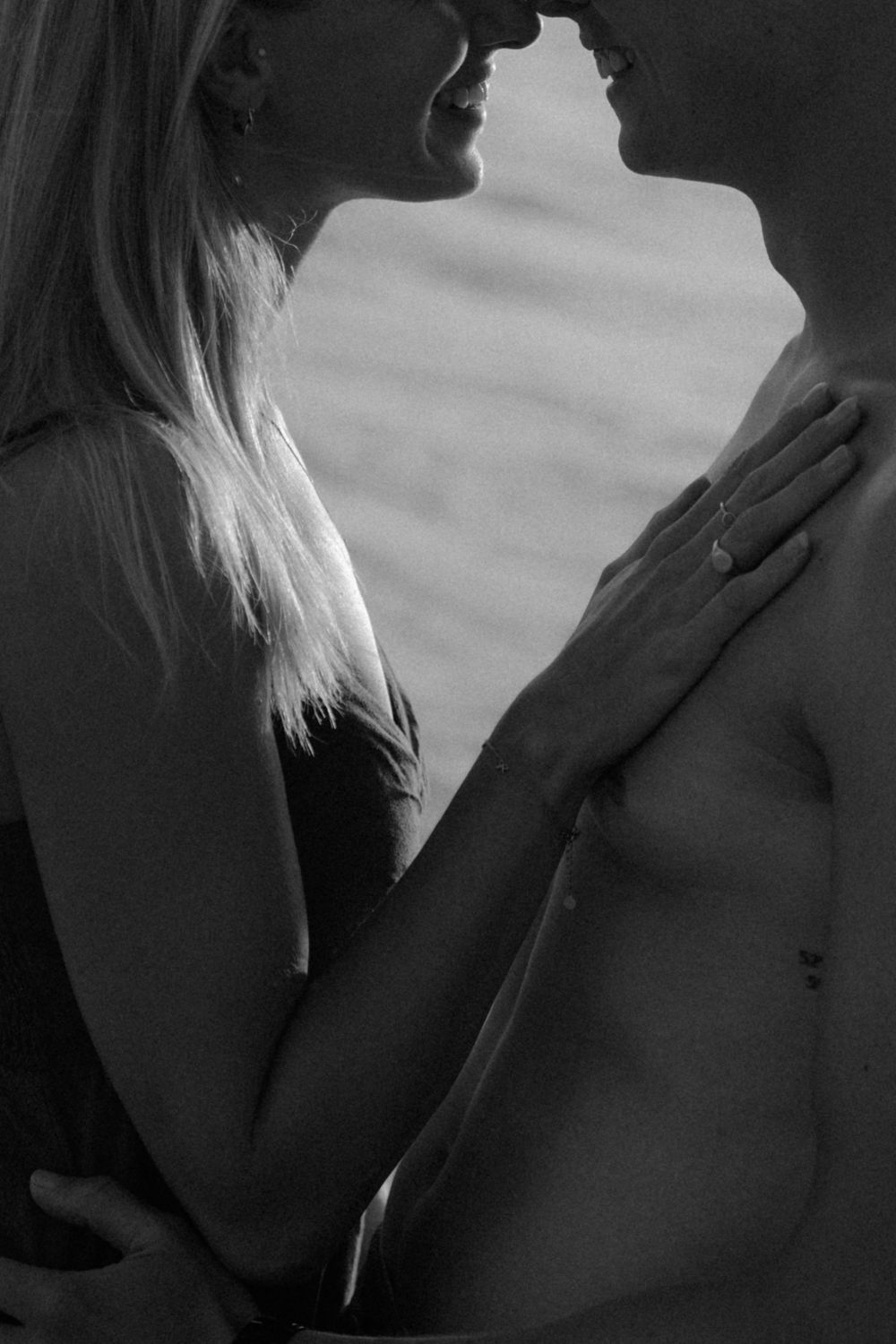 Artistic black and white intimate portrait series showing silhouettes and close-up details in dramatic lighting.