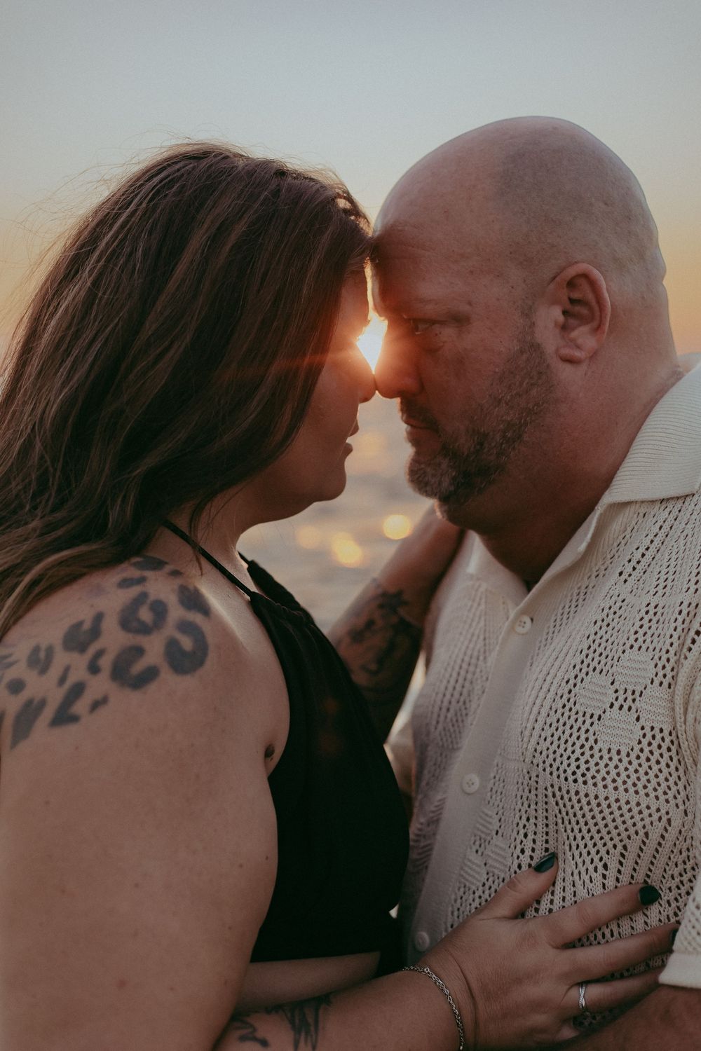 A romantic couple shares intimate moments in a series of sunset silhouette photos showing tender embraces and kisses.