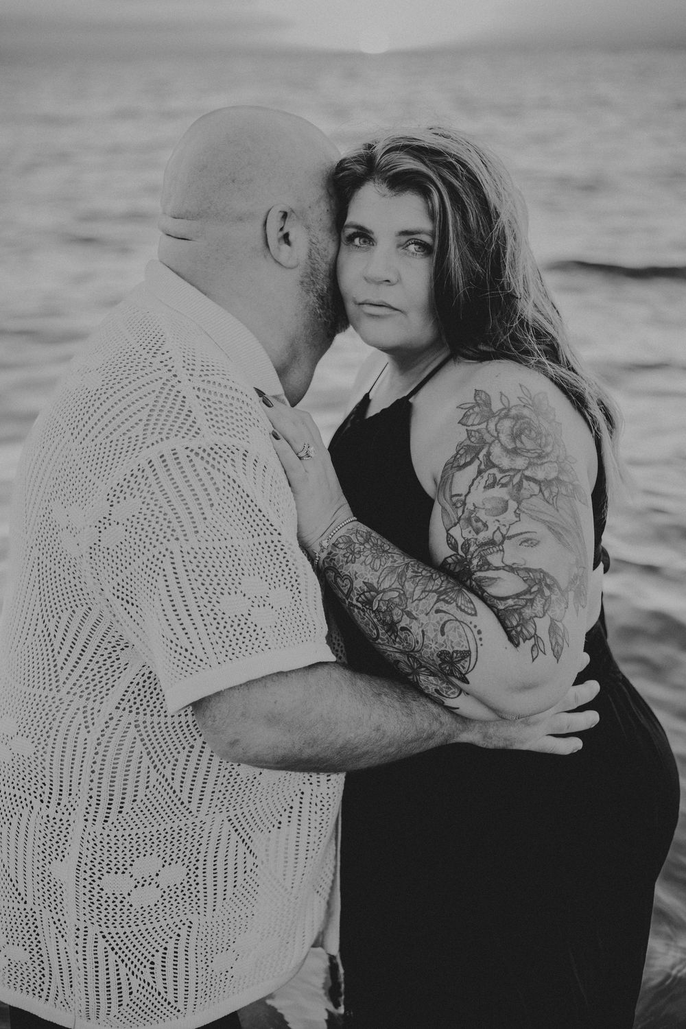 Black and white artistic photo series showing intimate moments between a couple by the water.
