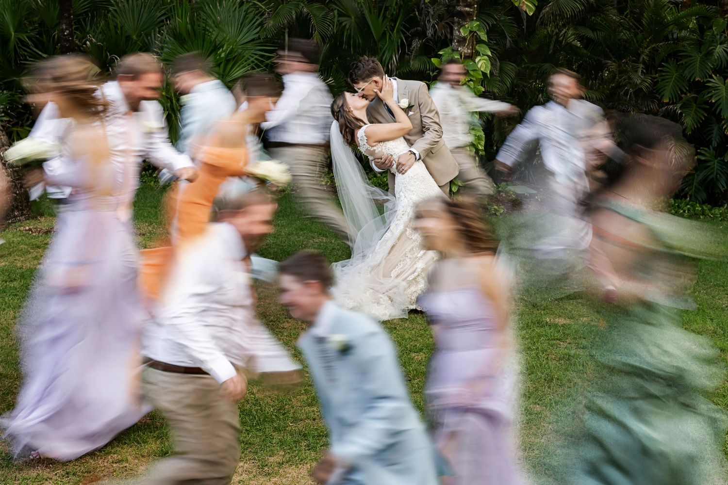 Emotional wedding portrait of Seth and Claire framed by palm leaves during their beach destination wedding at The Fives Beach Hotel.