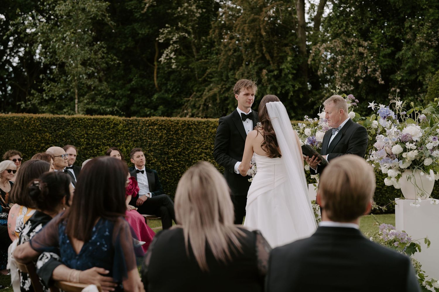 groom looking at bride during wedding ceremony at dewsall court in herefordshire