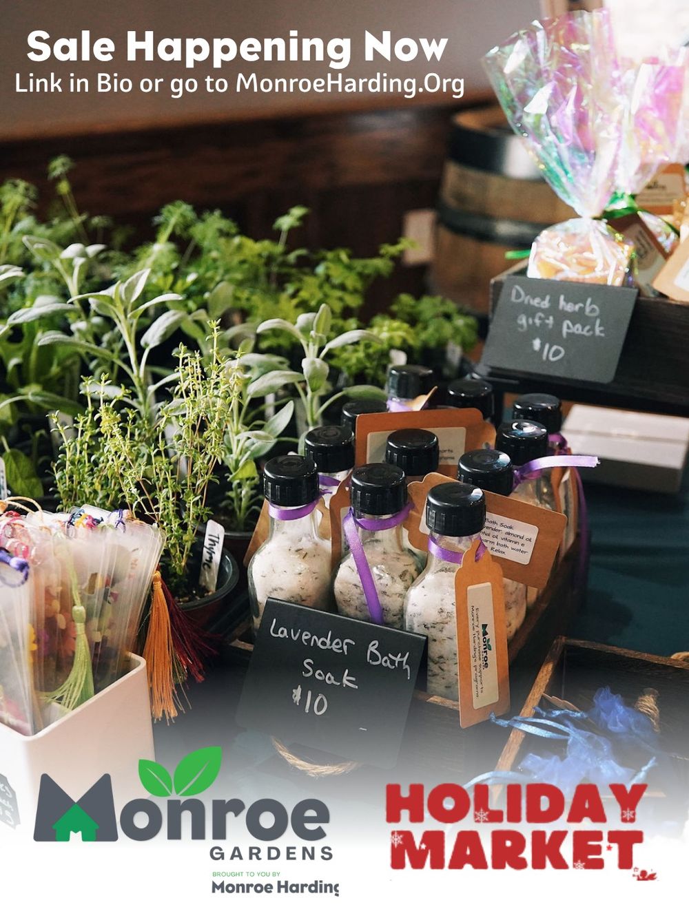 Holiday market display featuring herbs, plants and bottled products for sale.