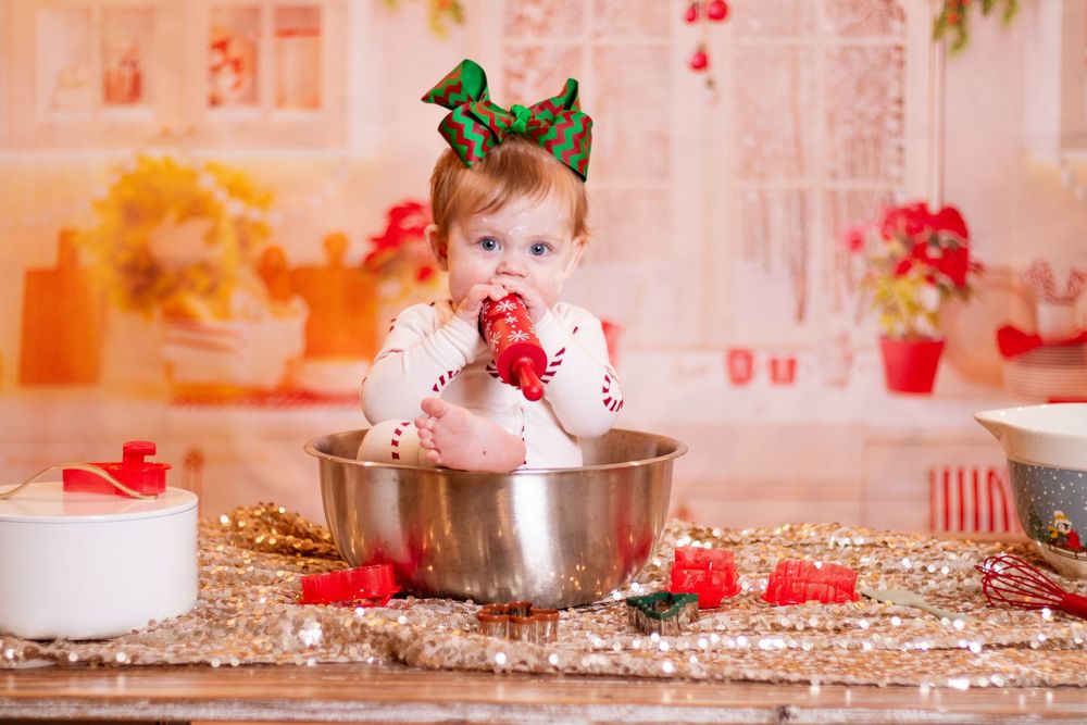 A festive Christmas-themed photo collage with red and pink decorations and holiday props in a studio setting.