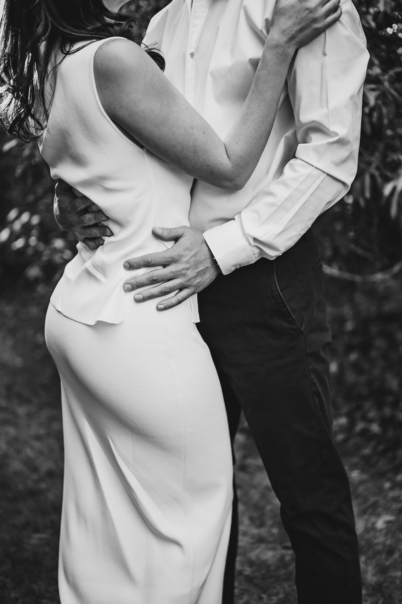 Artistic black and white close-up shots of a couple in formal attire.
