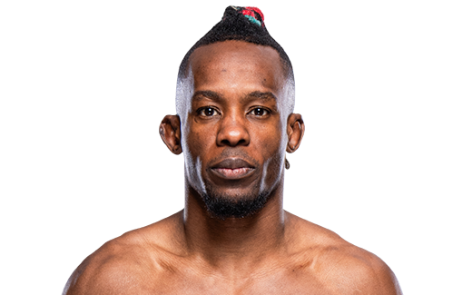 Mixed martial arts athlete poses for headshot wearing small black earpiece against dark background.